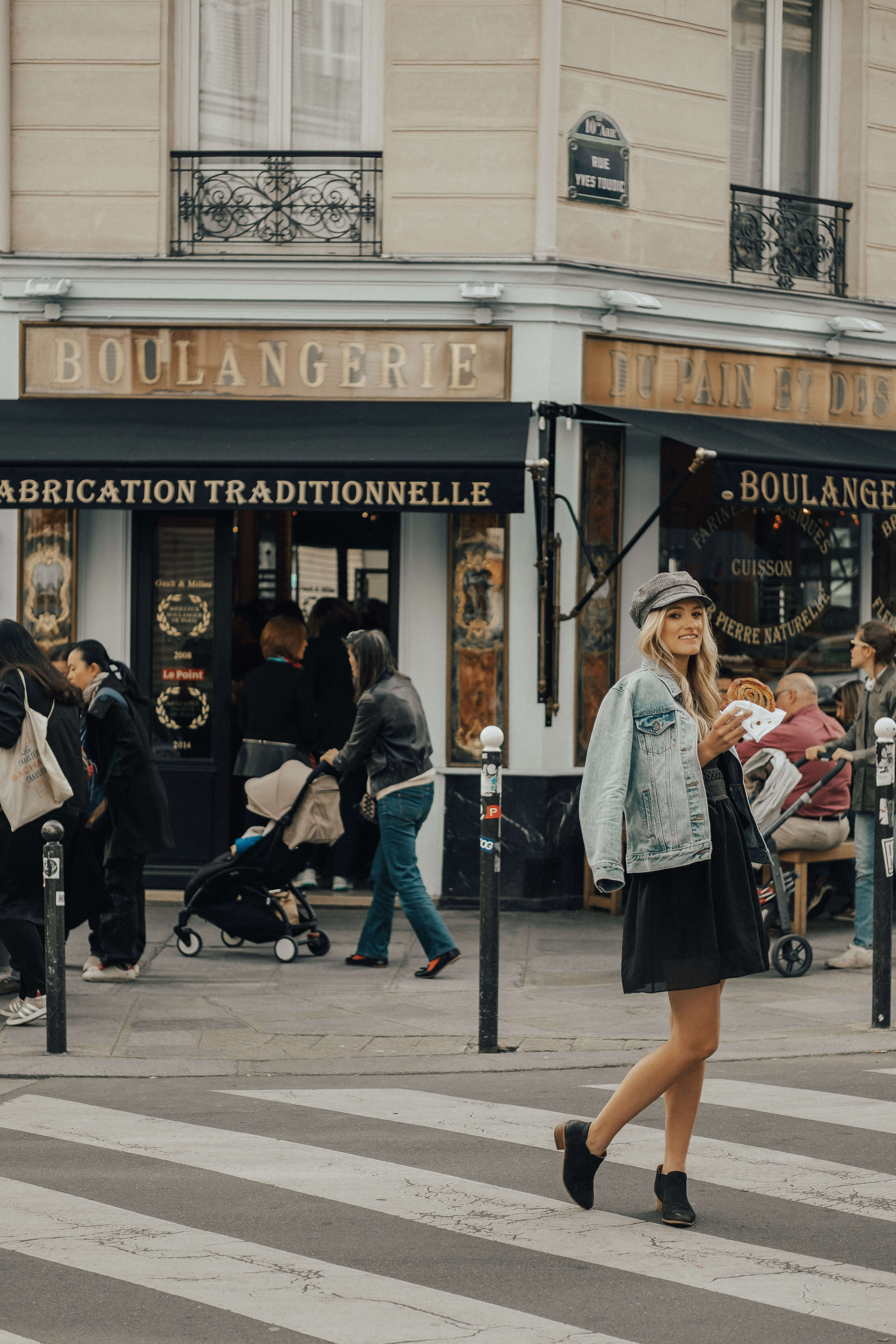 Girl in front of Au Pain et Des Idees Bakery Paris